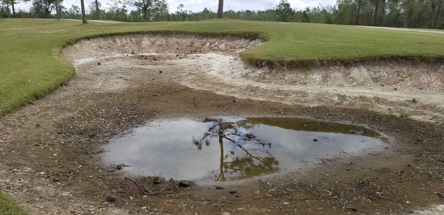 A poorly-draining golf course bunker before renovation