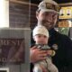 New Eagle Crest Golf Club owner Scott Battiste holds son Archie in the pro shop. The 34-year-old from Niskayuna went from head pro to owner last September