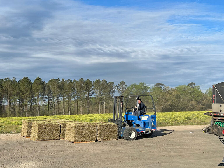Billy Jo Williams moving pallets of sod at Green Acres Turf.