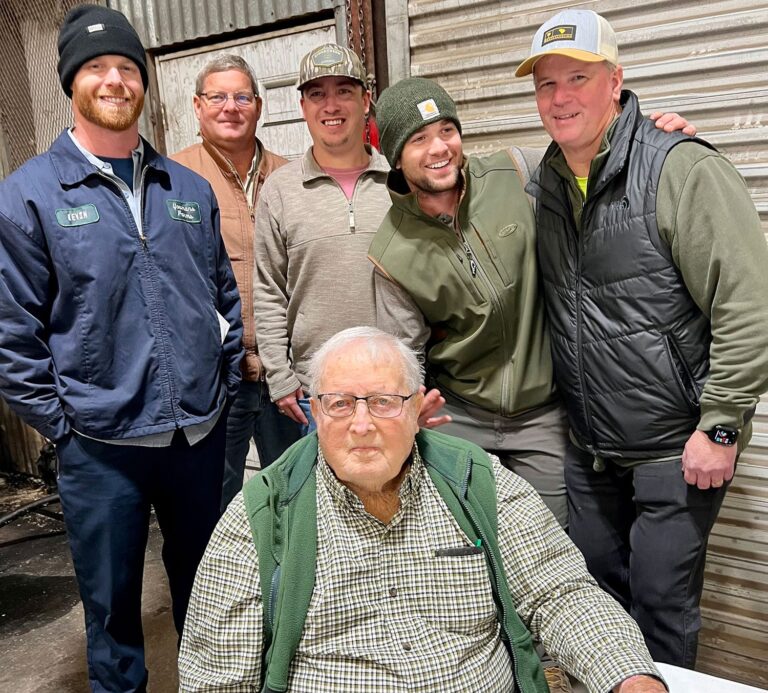 Kevin Youmans, Alex Youmans, Tanner Hinson, Grant Youmans, Gary Youmans and Lynn Youmans (seated) in the farm’s repair shop during Christmas 2022.