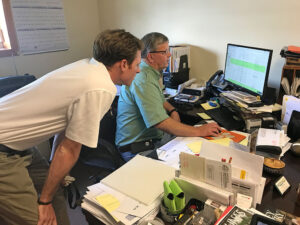Sod Solutions Southeast Territory Manager, Whit Jacobs, and Gary Youmans looking at Turf Logistics™ Software.